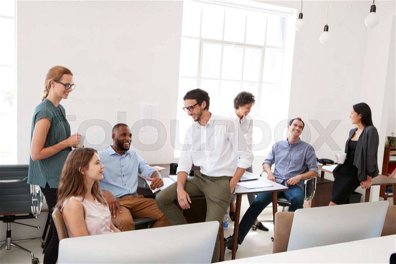Young business colleagues at casual meeting in their office, stock photo