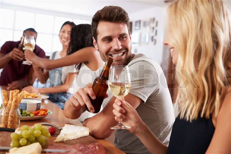 Group Of Friends Enjoying Dinner Party At Home Together, stock photo
