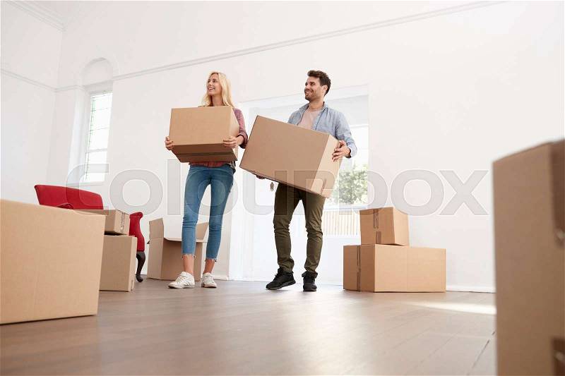 Couple Carrying Boxes Into New Home On Moving Day, stock photo