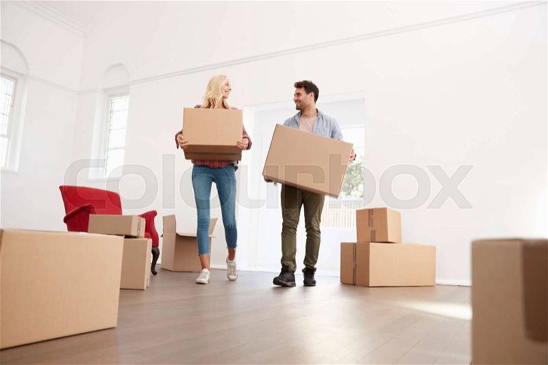 Couple Carrying Boxes Into New Home On Moving Day, stock photo