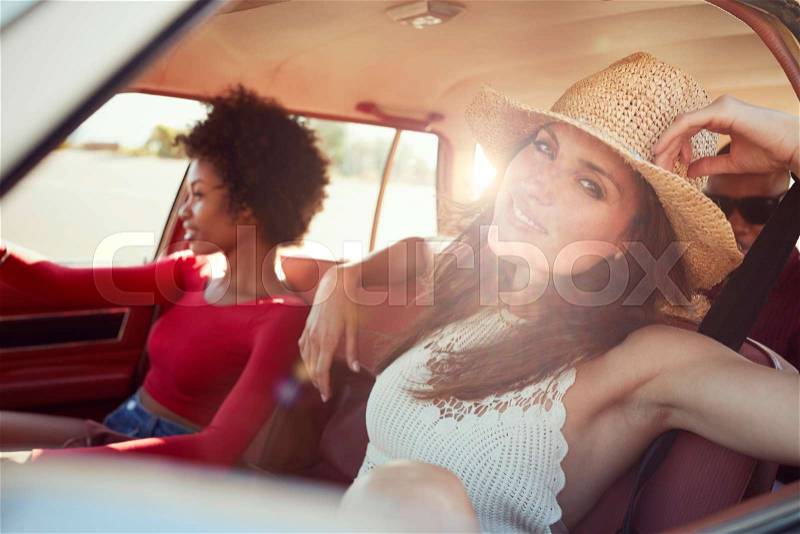 Portrait Of Friends Relaxing In Car During Road Trip, stock photo