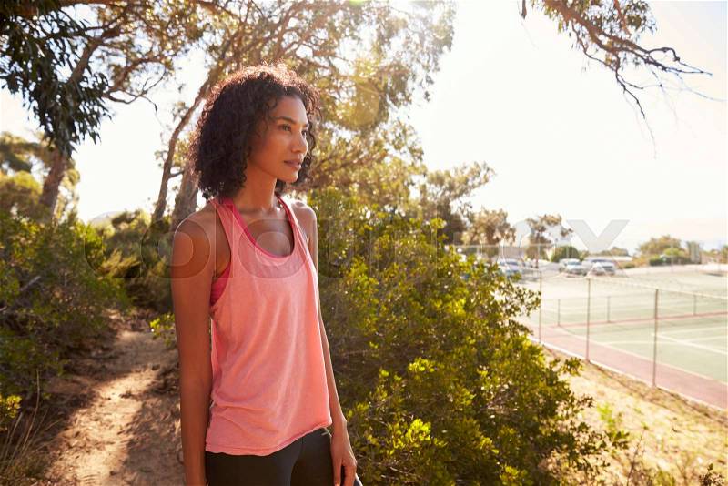 Young black woman taking a break during her run, stock photo