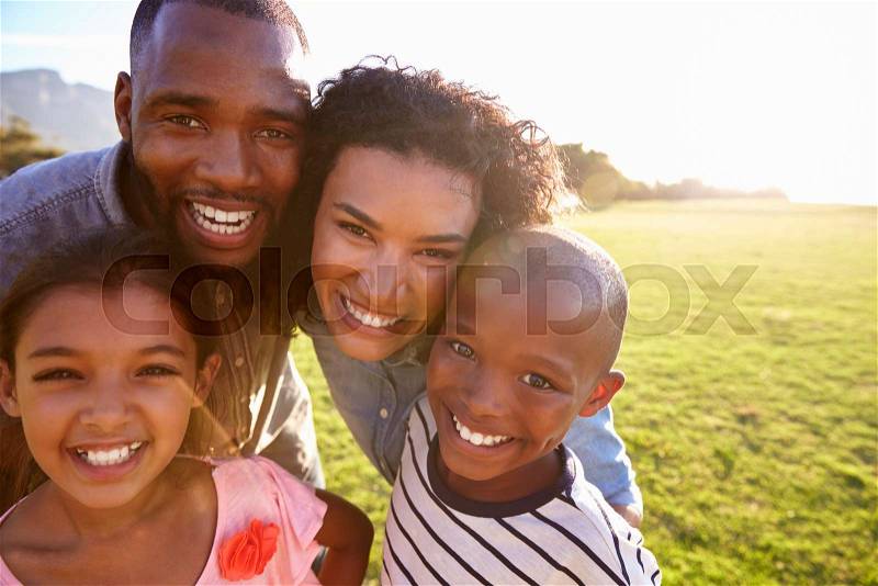 Portrait of a smiling black family outdoors, close up, stock photo
