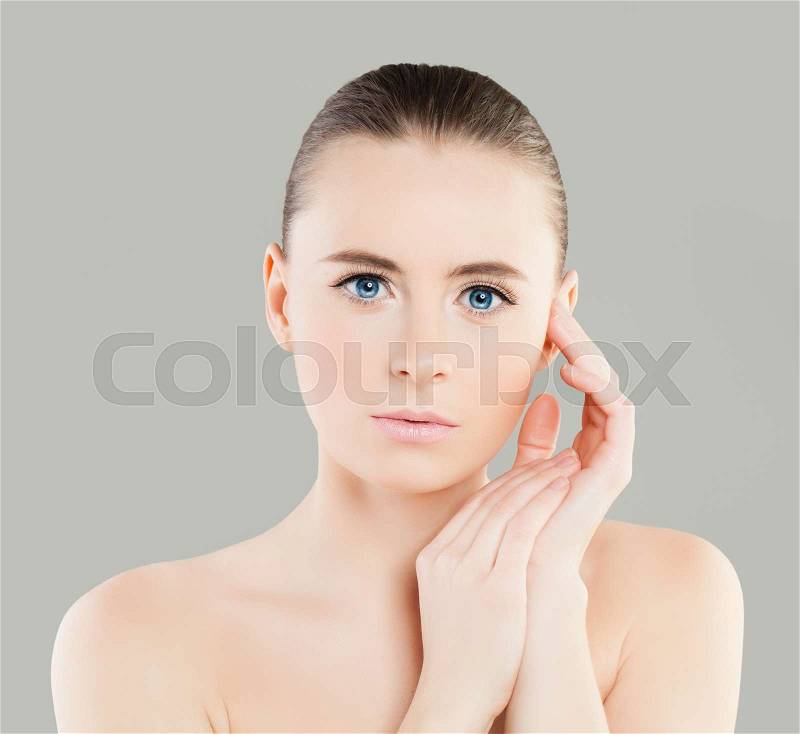 Beautiful Female Face. Spa Model Woman with Healthy Skin touching her Hand her Face. Spa Beauty, Facial Treatment and Cosmetology Concept, stock photo