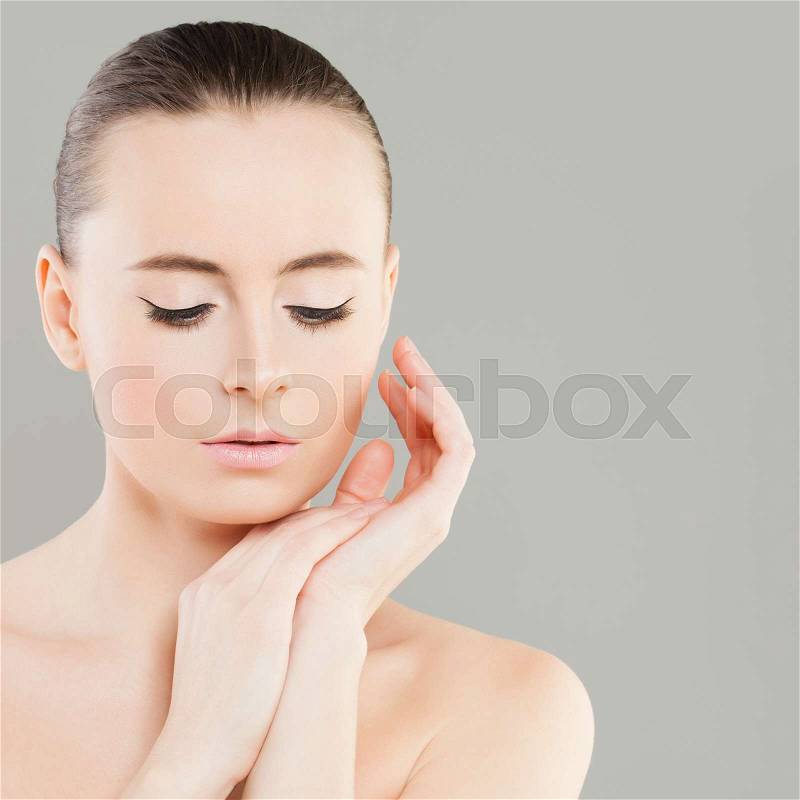 Spa Beauty. Perfect Woman with Healthy Skin touching her Hand her Face. Spa Beauty, Facial Treatment and Cosmetology Concept, stock photo