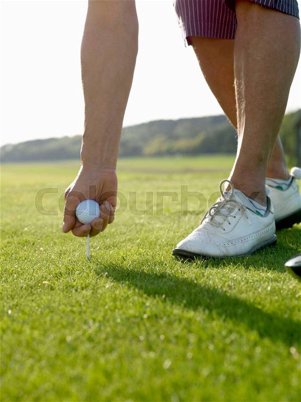 Woman on golf tee, stock photo