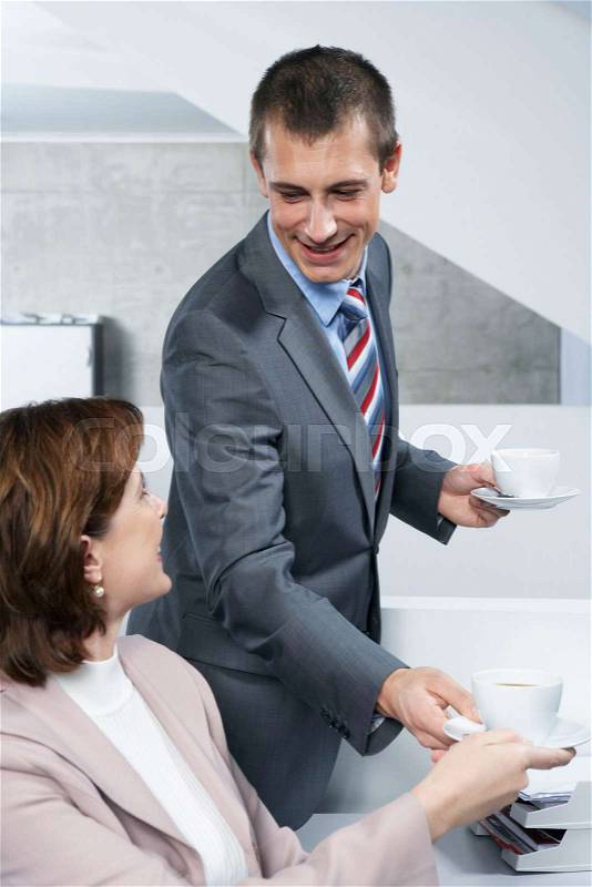 Colleagues sharing coffee, stock photo