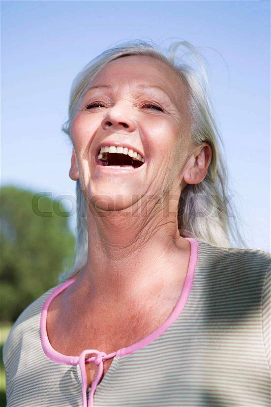 Mature woman portrait laughing, stock photo