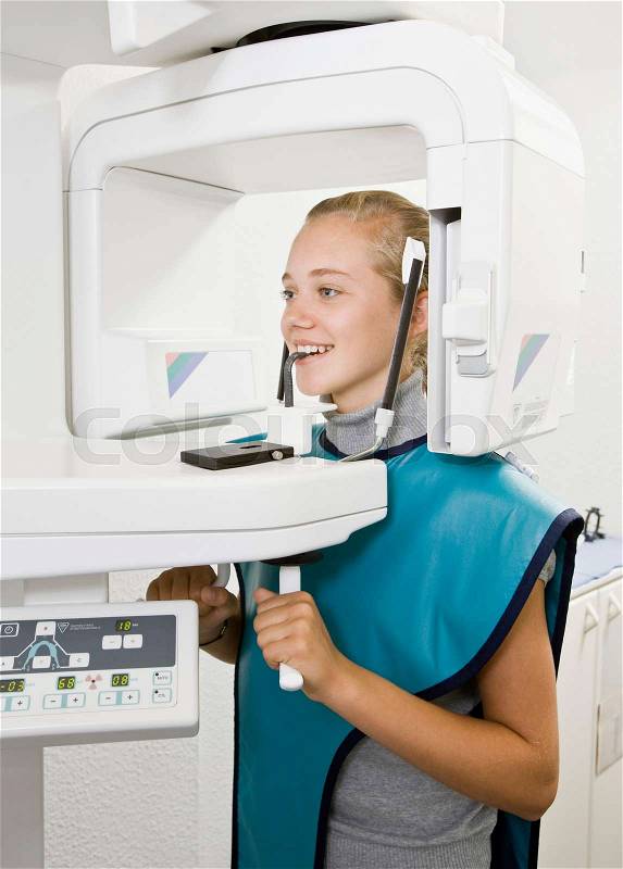 Dental patient getting an x-ray taken, stock photo