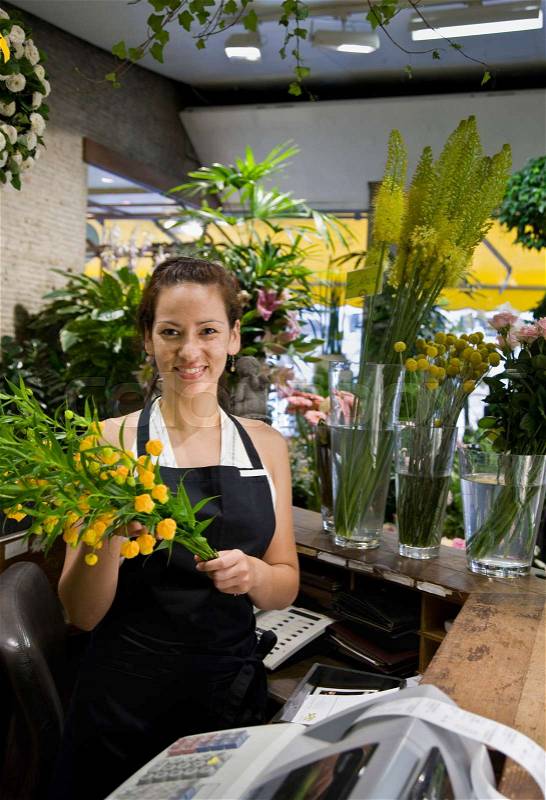 Female clerk in a flower shop, stock photo