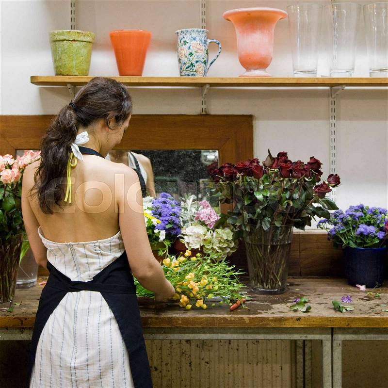 Female clerk in a flower shop, stock photo