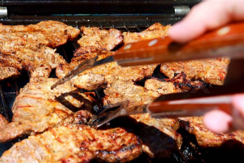 Outdoor grilled pig meat on grill, stock photo