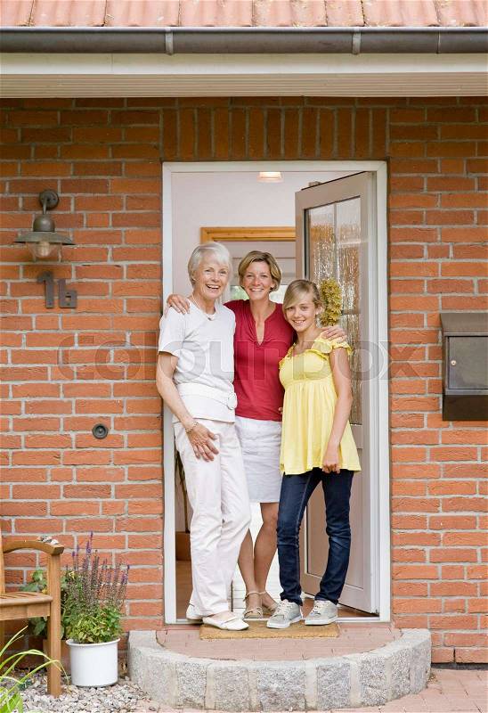 Family at the door way of a house, stock photo
