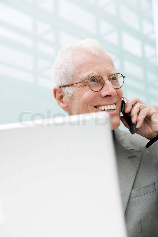Older man using cell phone, stock photo
