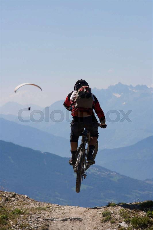 Mountain biker jumping into the air, stock photo