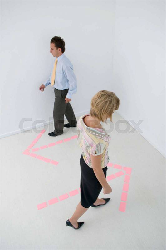 Business people following arrows, stock photo