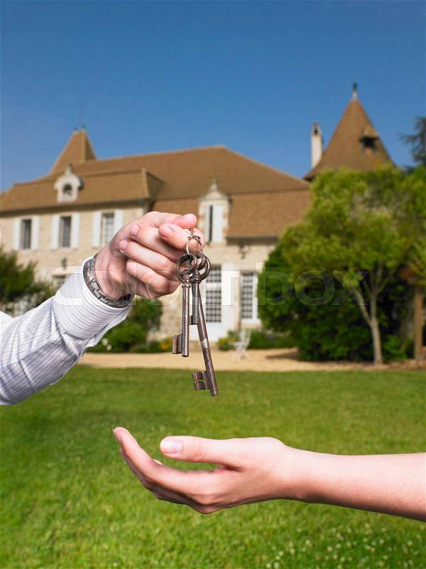 Woman receiving keys to country home, stock photo