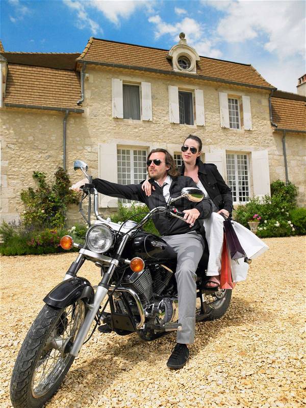 Couple on motorbike, stock photo