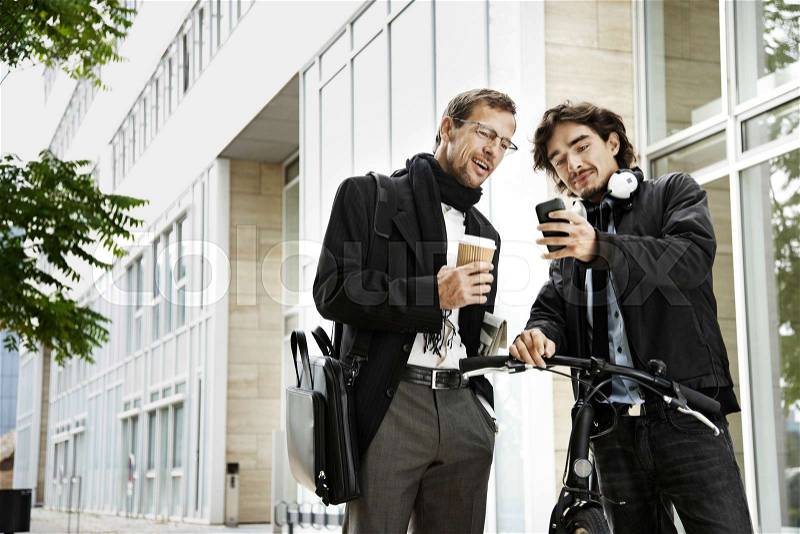 Men next to bicycle, coffee break, stock photo