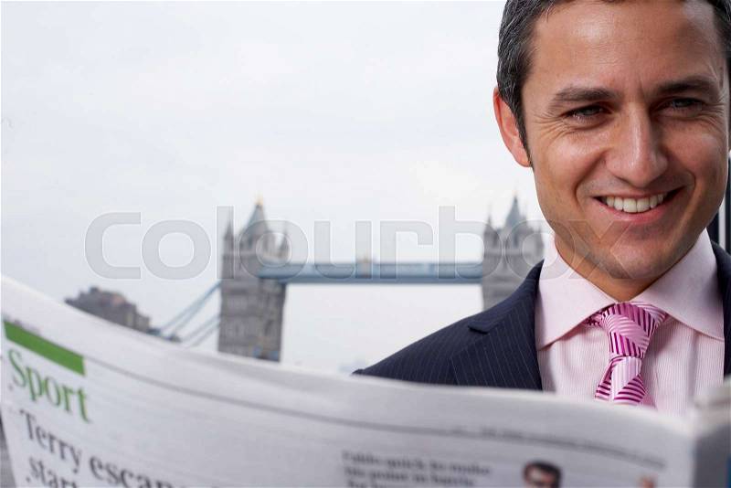 Business man reading news paper outside, stock photo