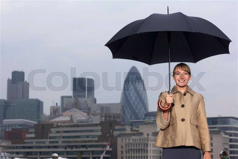 Woman with umbrella city scape, stock photo
