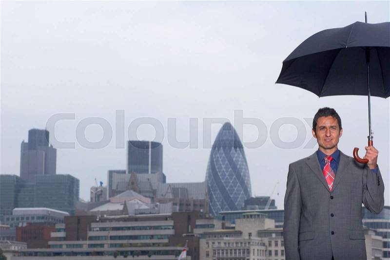Mann with umbrella city scape, stock photo
