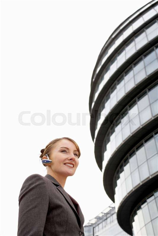Business woman using bluetooth headset, stock photo