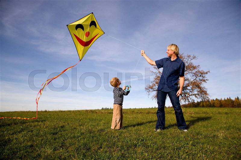 Boy and father fly a Kite, stock photo
