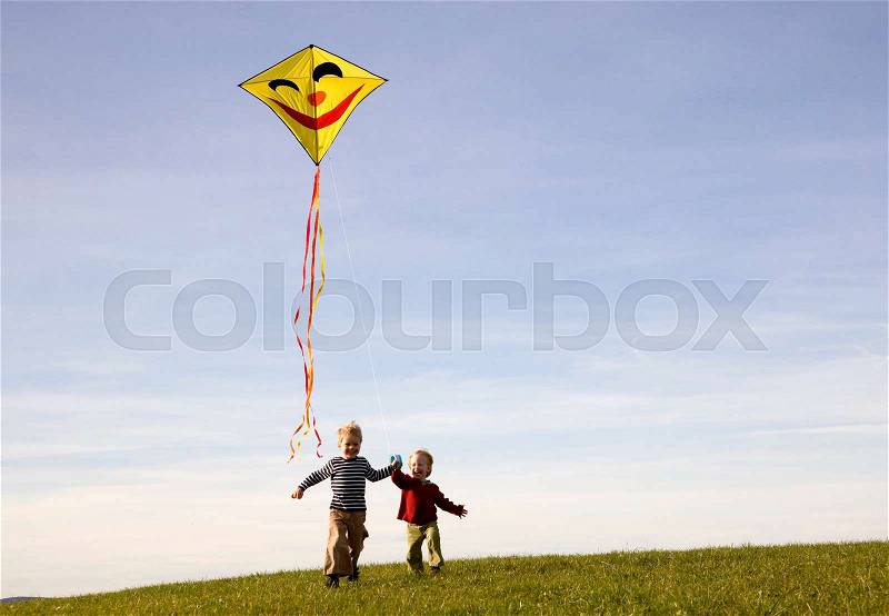 Two Boys fly a Kite, stock photo