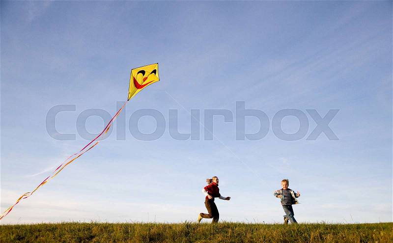 Girl and Boy fly a Kite, stock photo