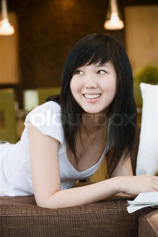 Smiling teen looking over shoulder, stock photo