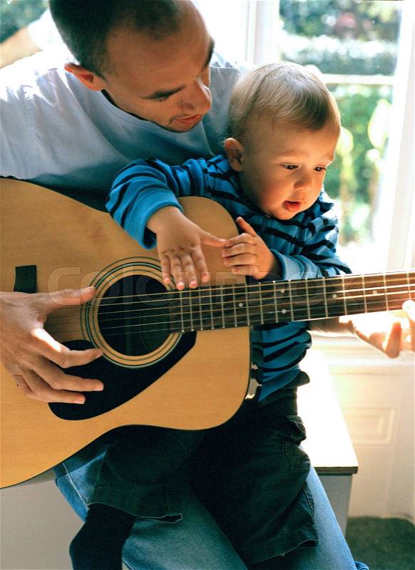 Father and Son Playing Guitar, stock photo