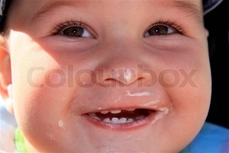 Yearly child with smiling with dirty mouth, stock photo