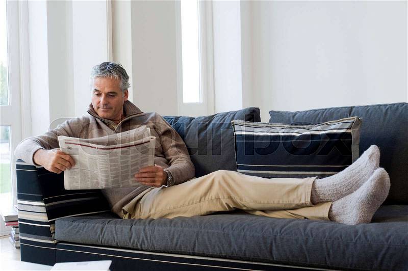 Man reading newspaper, stock photo