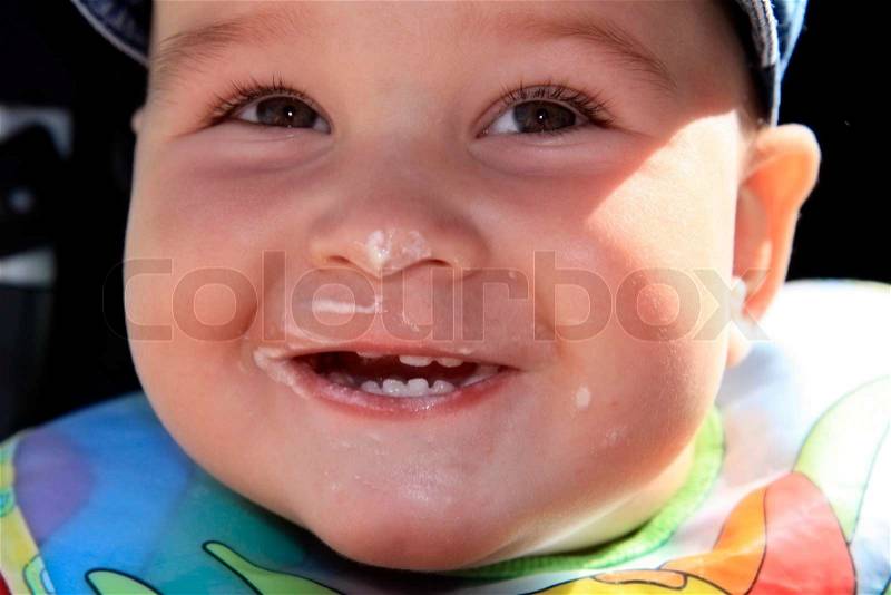 Yearly child with smiling with dirty mouth, stock photo