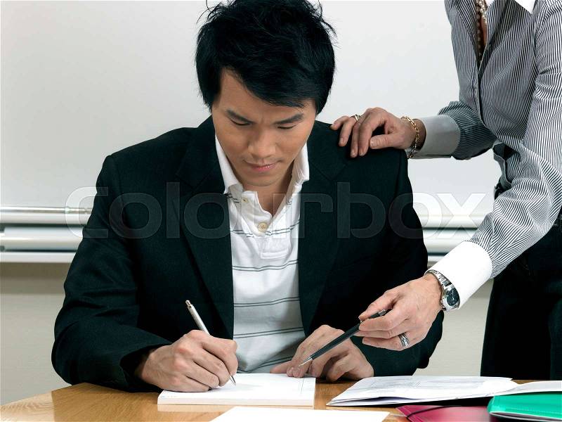 Business woman helping trainee, stock photo
