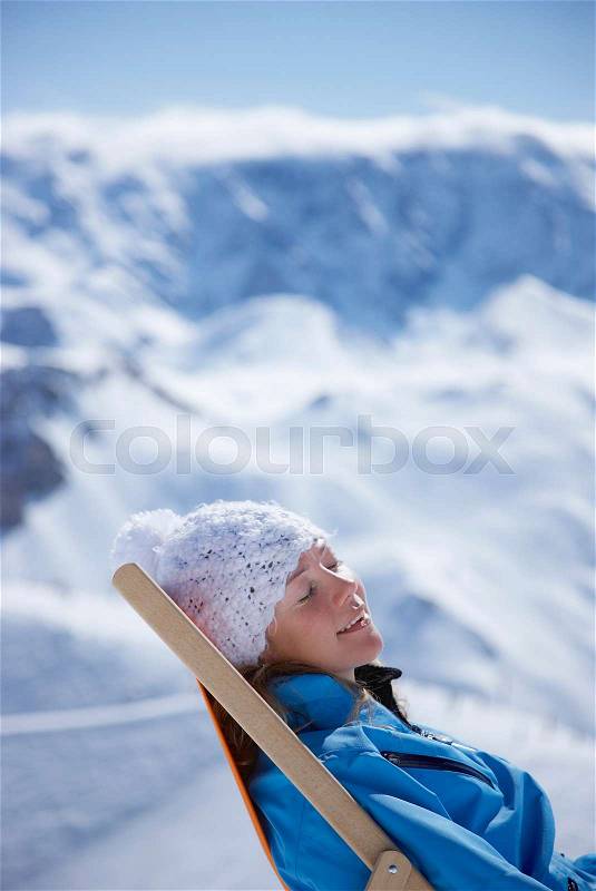 Woman reclining in deck chair, stock photo