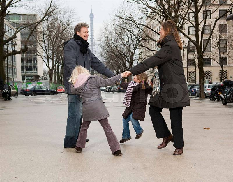 Family dancing near Eiffel Tower, stock photo