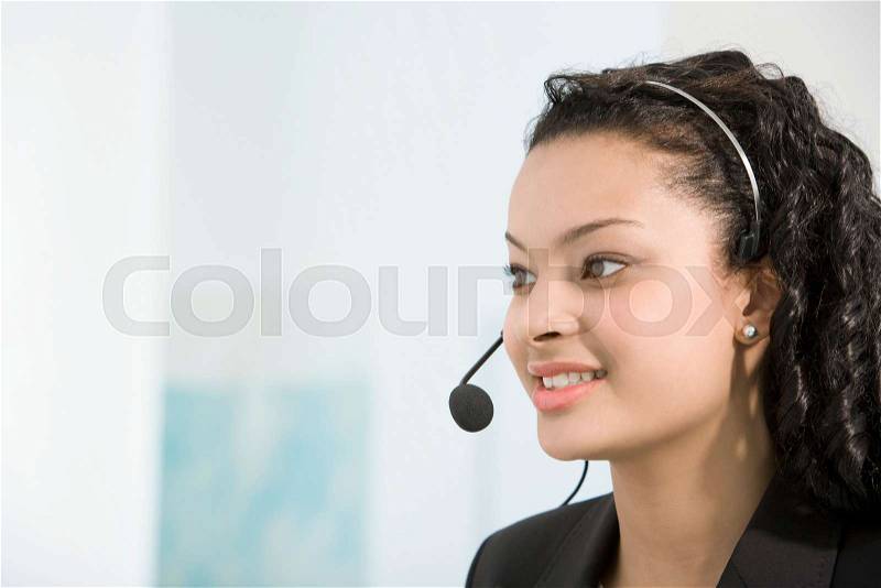 A telephone operator talking into a mic, stock photo
