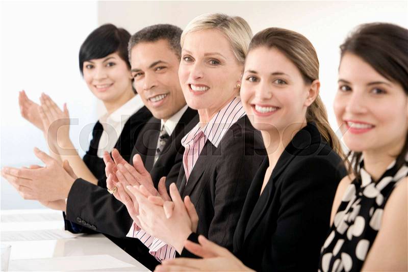 A line of business people clapping, stock photo