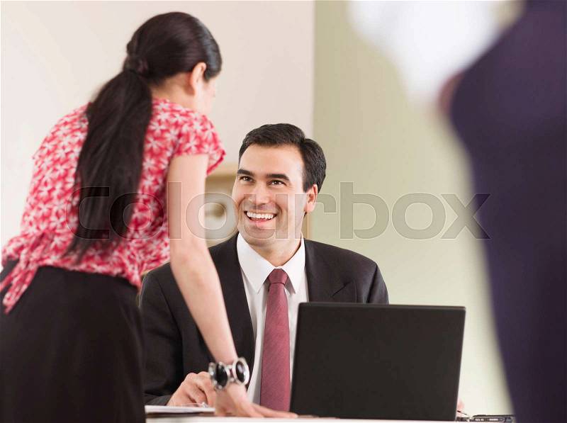 A business man talking to a colleague, stock photo