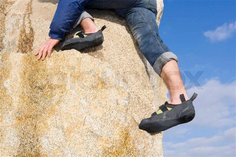 Climber free climbing boulder, stock photo