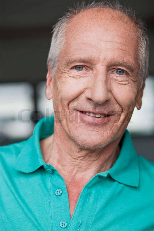 Old man smiling at viewer, stock photo