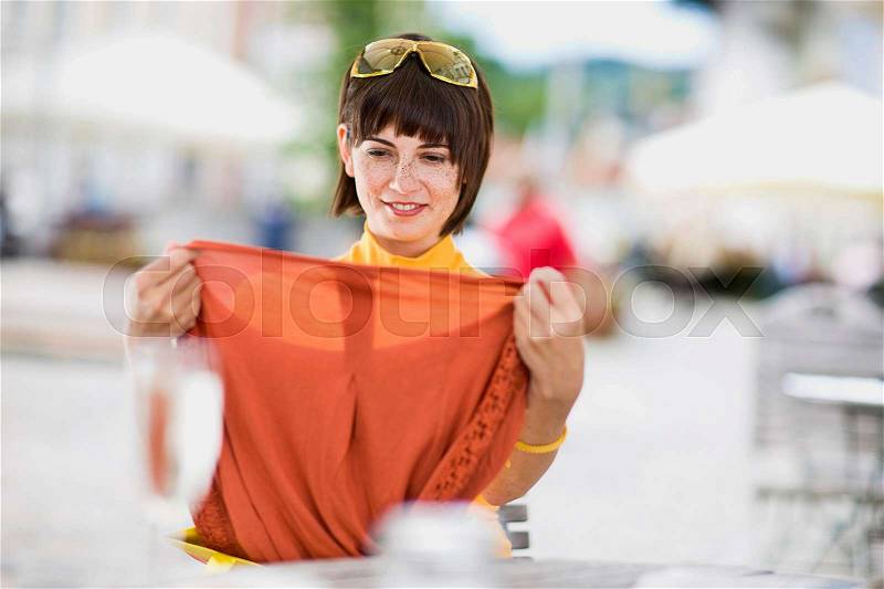 Woman shows her brand new clothing, stock photo