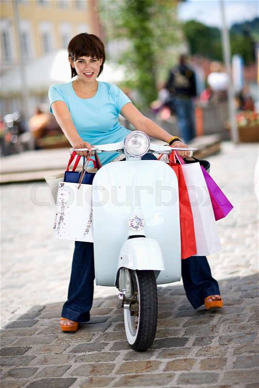 Woman with motor scooter, stock photo