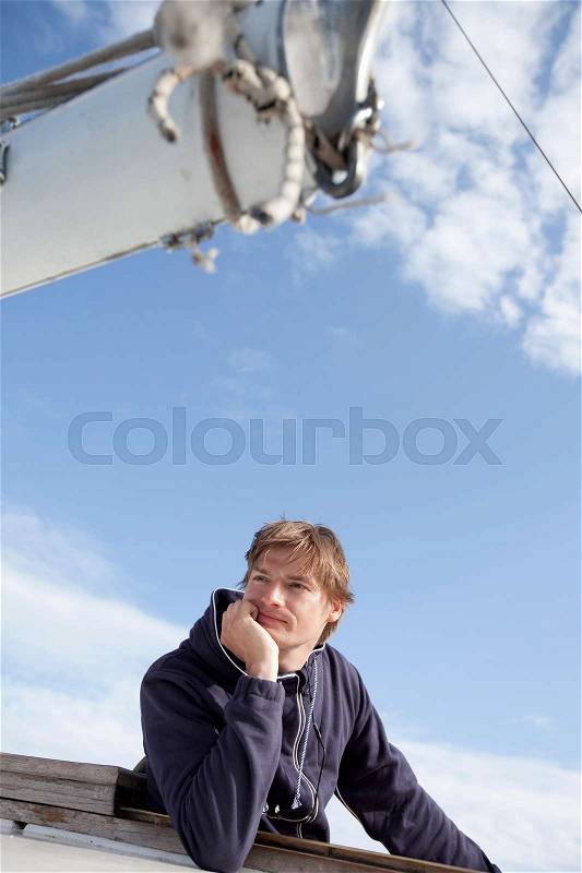 Man on a boat looking at the sea, stock photo