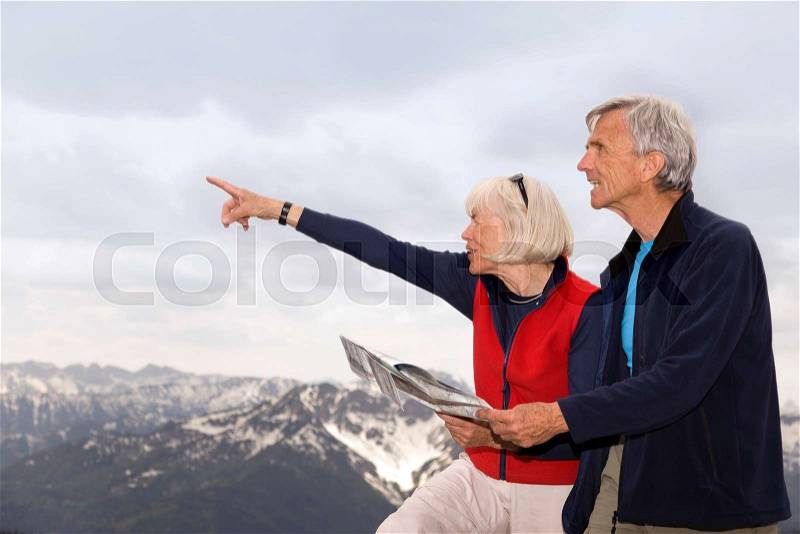 Senior couple on mountain summit, stock photo