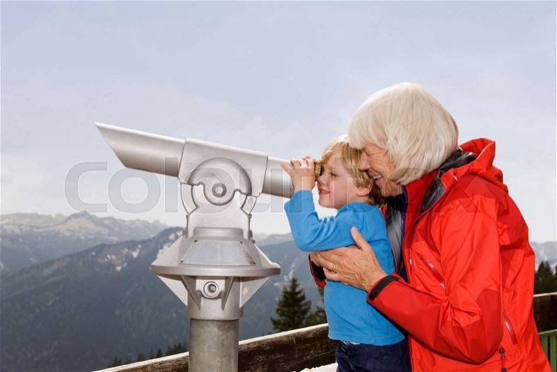 Boy, grandma looking through telescope, stock photo