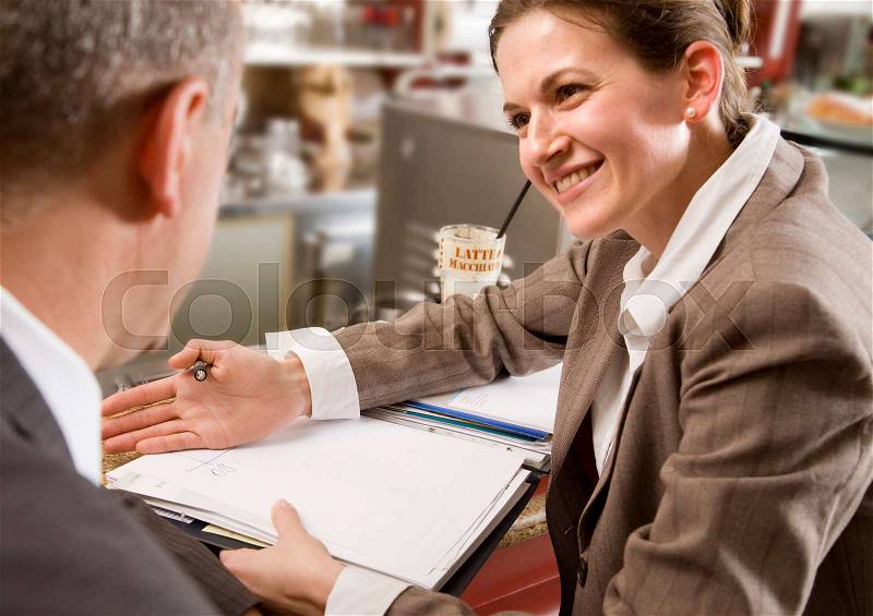 Woman and man having discussion at bar, stock photo