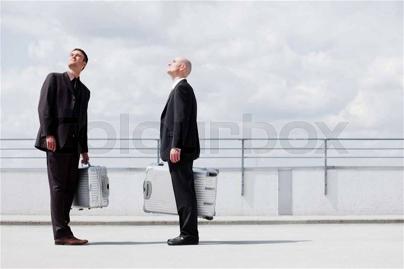 Two business men with suitcases, stock photo